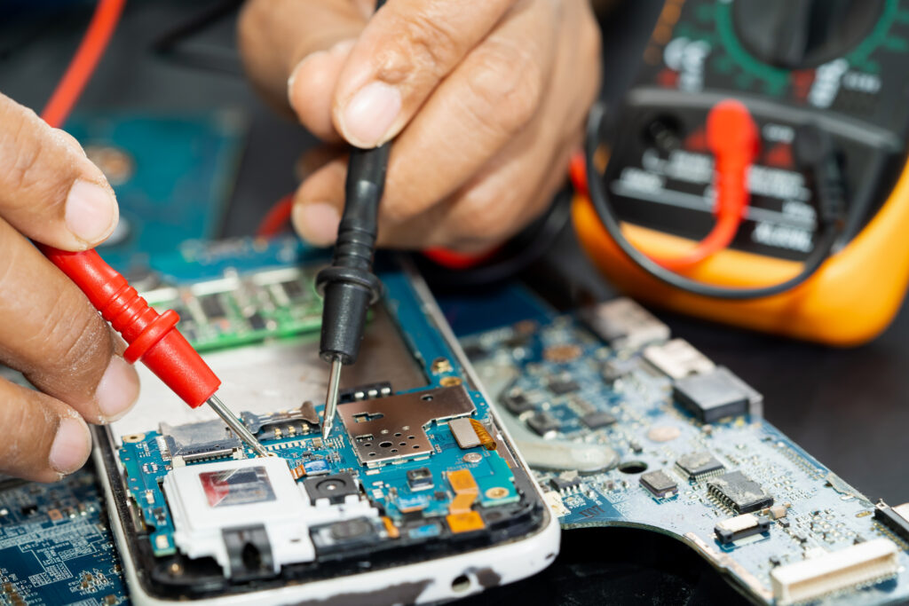 Mobile Repair technician repairing inside of mobile phone by soldering iron. i